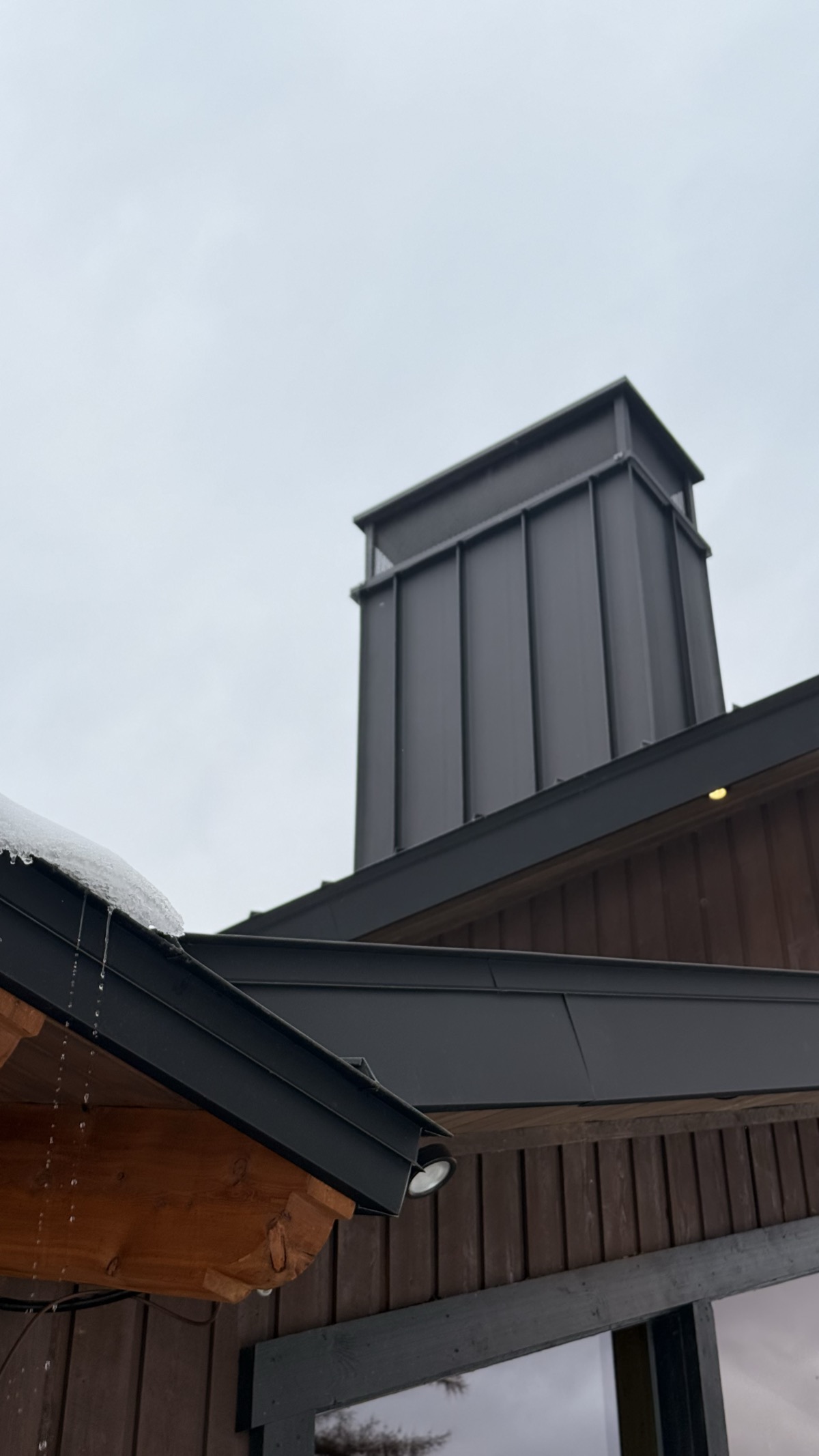 Chimney flashing and wrapped fascia — zero exposed fasteners